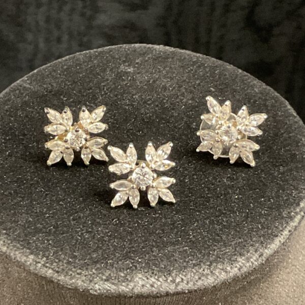 Delicate silver snowflake earrings with white stones.