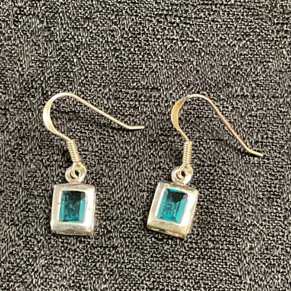 Silver topaz earrings with square gemstones in a classic dangle style.