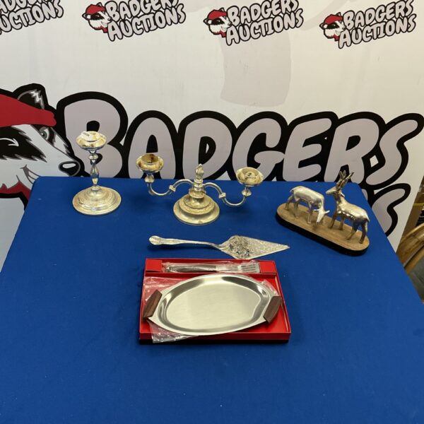 Vintage silverplate collection featuring a candlestick and decorative items.
