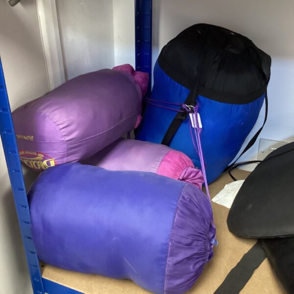 Lot of four colourful sleeping bags for camping and travel.