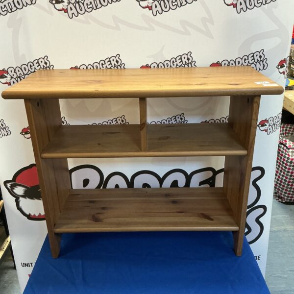 Small pine media cabinet with two shelves for storage.