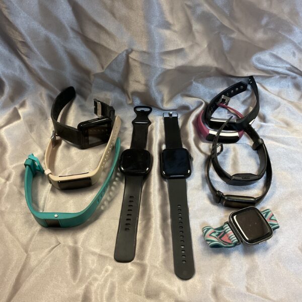Overview of a lot of ten smart watches and fitness trackers.