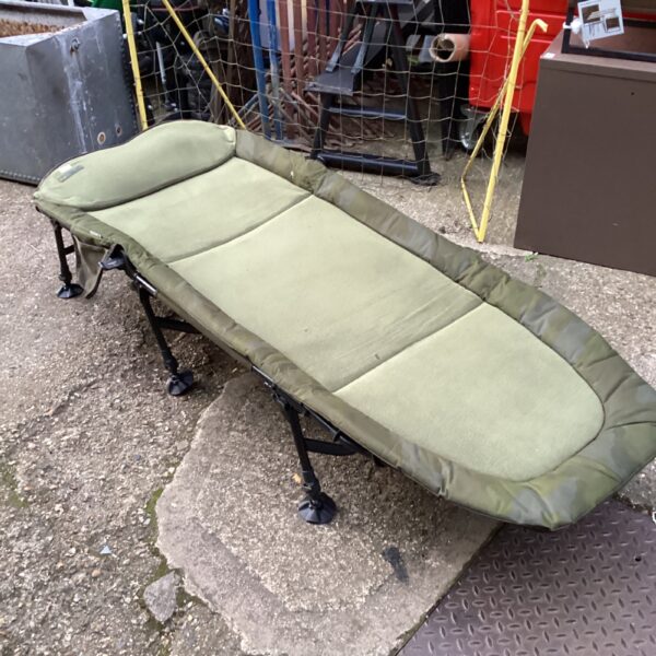 Used Sonik fishing bed chair for carp angling sessions.