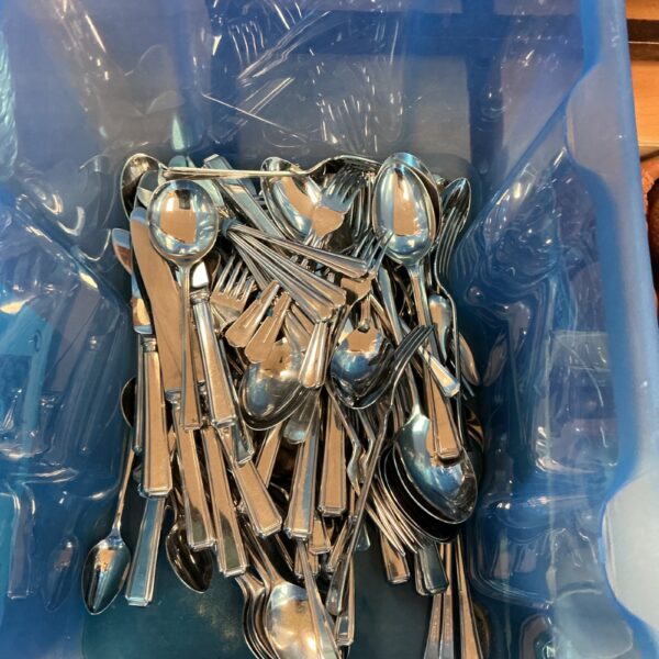 Large lot of stainless steel cutlery for kitchen and dining.