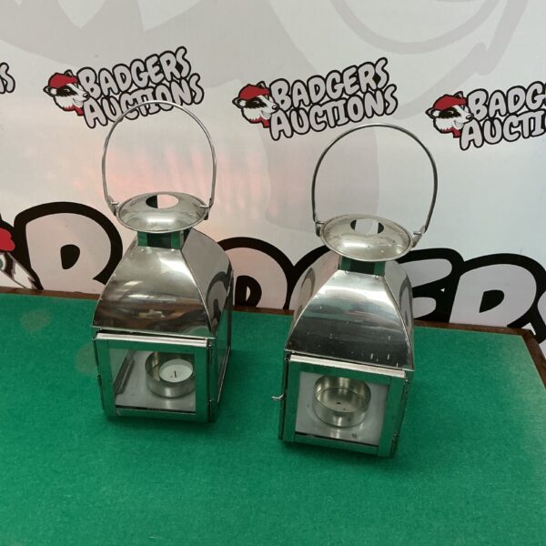 Pair of stainless steel lanterns with handles, modern home decor.