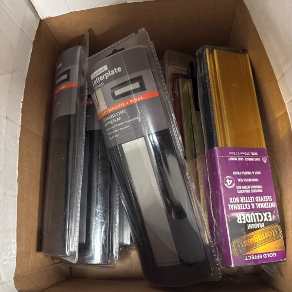 Assorted new stainless steel letter boxes in original packaging.