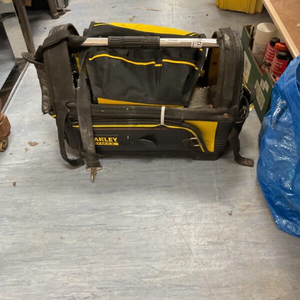 Close-up of a used Stanley Fatmax tool bag with multiple pockets.