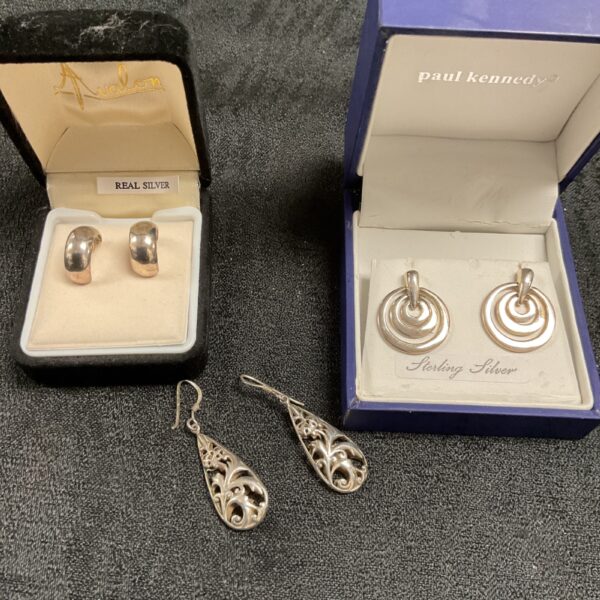 Close-up of a pair of sterling silver stud earrings in a velvet box.