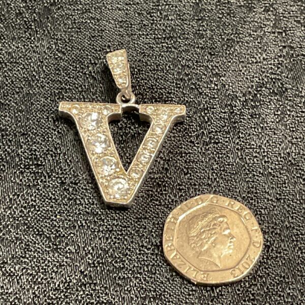Sparkling sterling silver 'V' pendant with white stones.