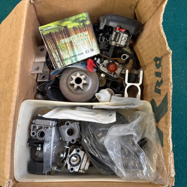 Assorted Stihl engine parts including a carburetor for small engines.