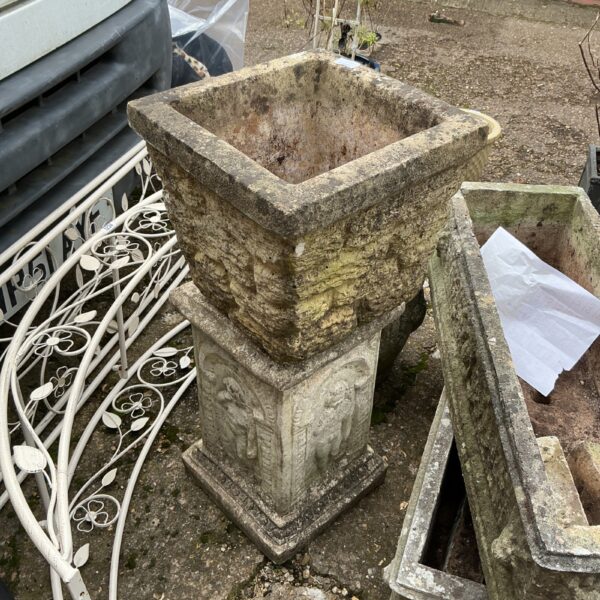 Antique stone garden planter with decorative moulding and weathered patina.