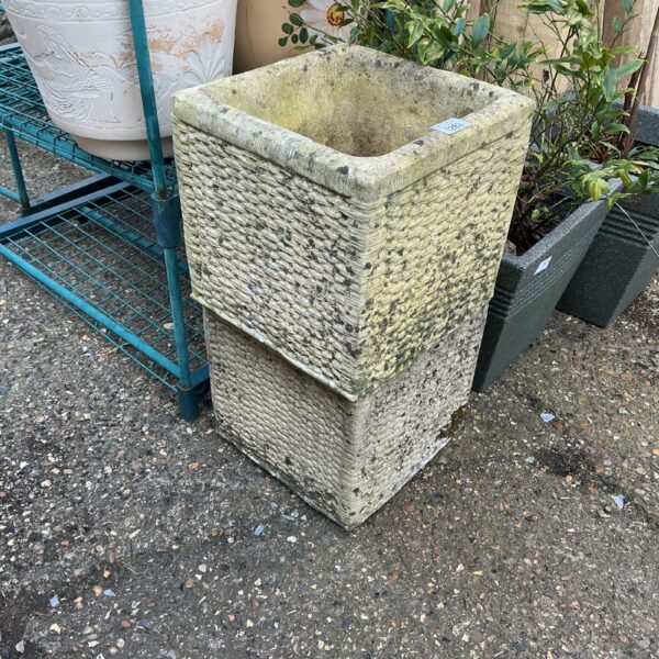 Rustic stone effect garden planter with basketweave design.