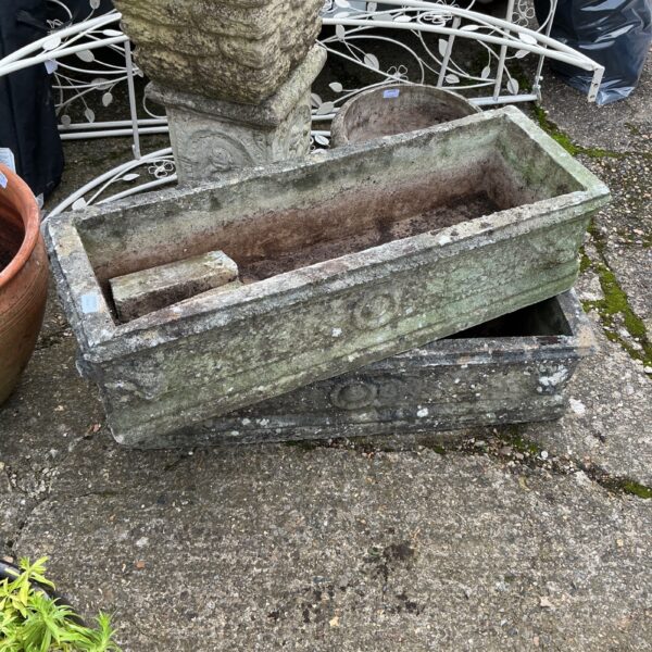Pair of weathered stone effect garden troughs for outdoor plants.