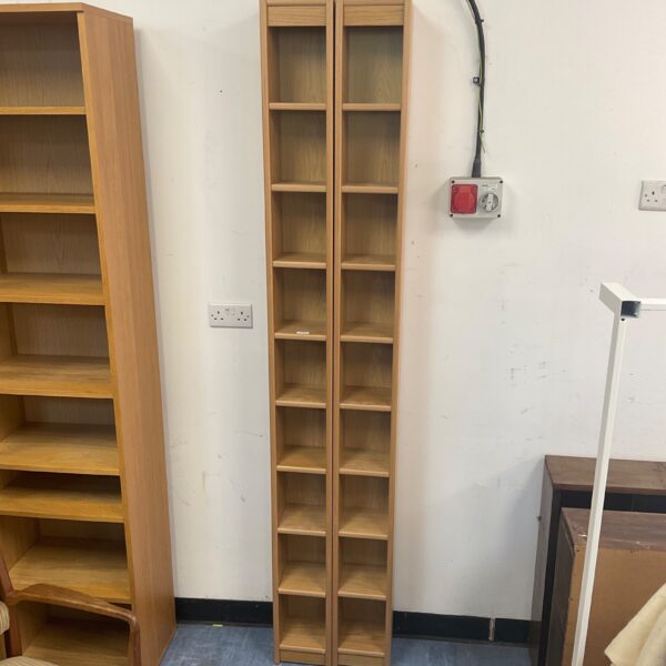 Tall oak effect CD storage cabinet with multiple shelves.