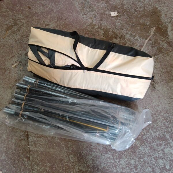 Beige tent and poles stored in a carry bag.