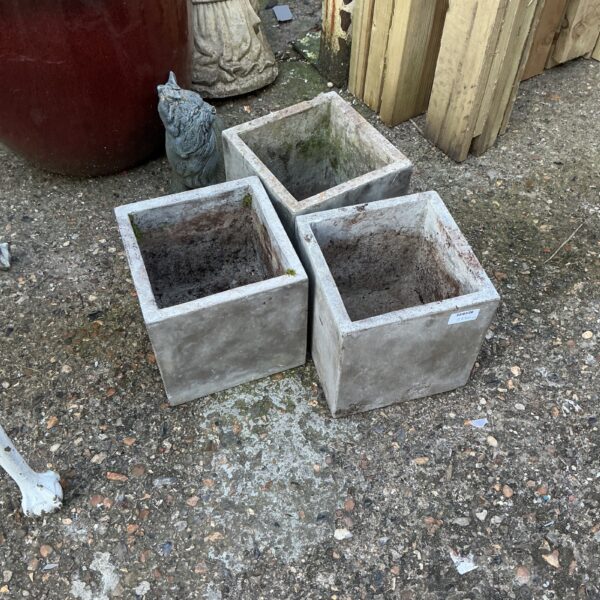 Three weathered garden tubs for outdoor plants and garden decor.