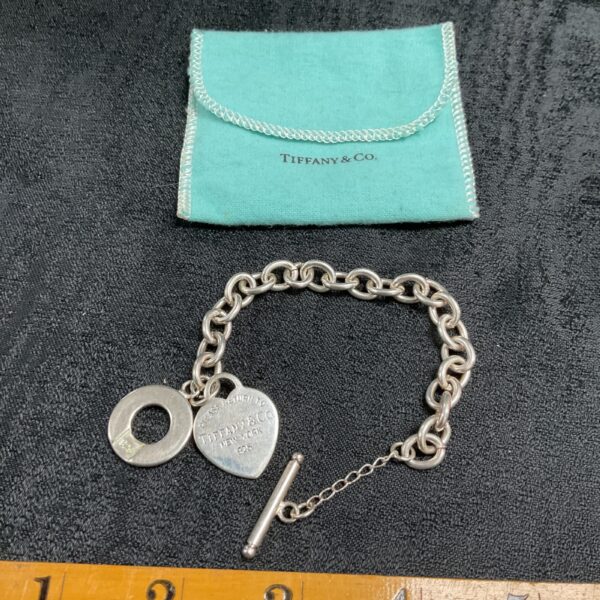 Vintage Tiffany & Co. silver charm bracelet with pendant.