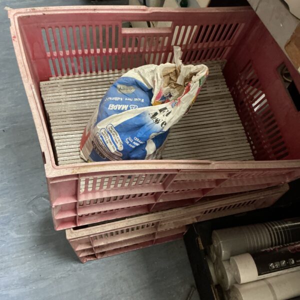 Mixed lot of tile adhesive and ceramic tiles for DIY projects.