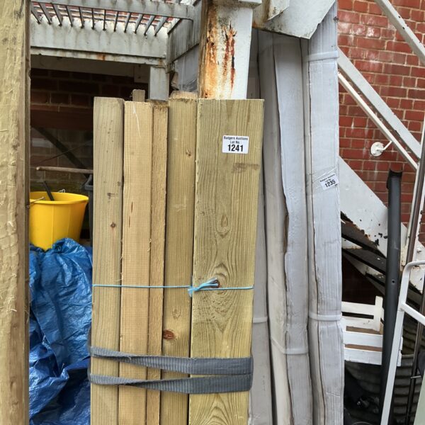 Stack of three timber bundles ready for construction projects.
