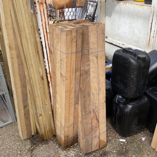Stack of three timber bundles for DIY projects.