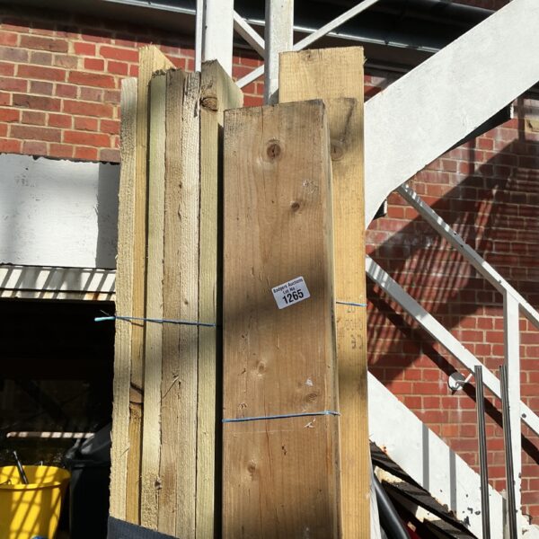 Three bundles of 7ft timber stacked outdoors, ready for construction.