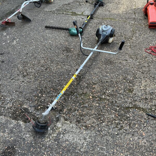 Used Titan petrol garden strimmer for lawn and garden maintenance.