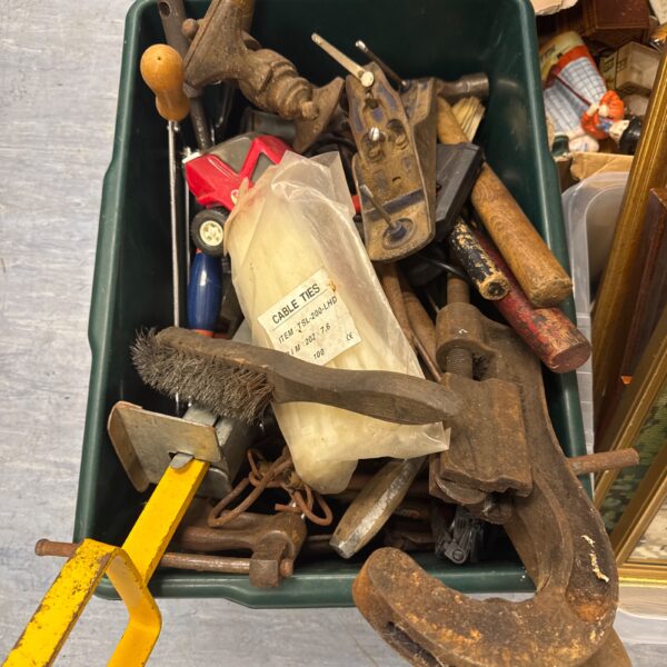 Vintage tool lot with bench clamp and assorted hand tools.