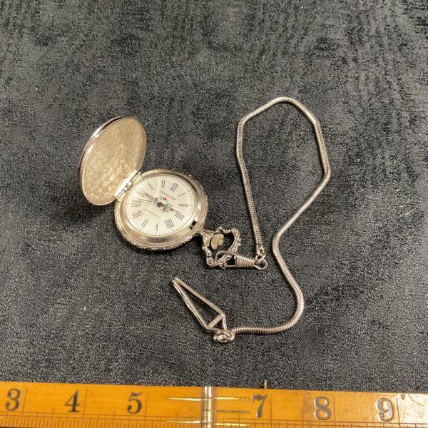 Vintage Trafalgar pocket watch with open cover.