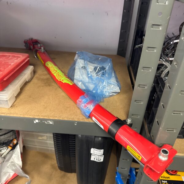 Red Trail Gator bicycle tow bar for towing a child’s bike.