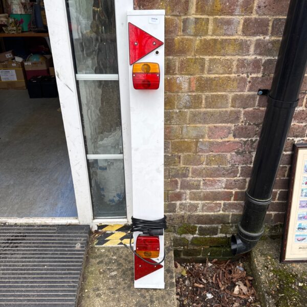 White trailer light board with rear lights for towing.
