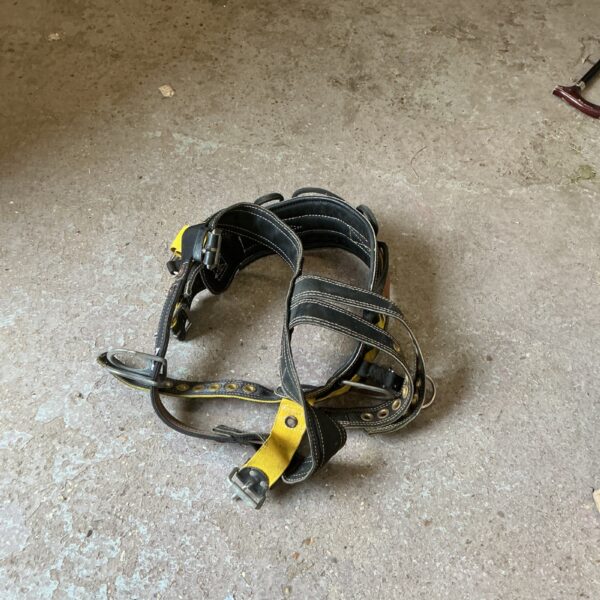 Front view of a used tree climbing harness for arborists.
