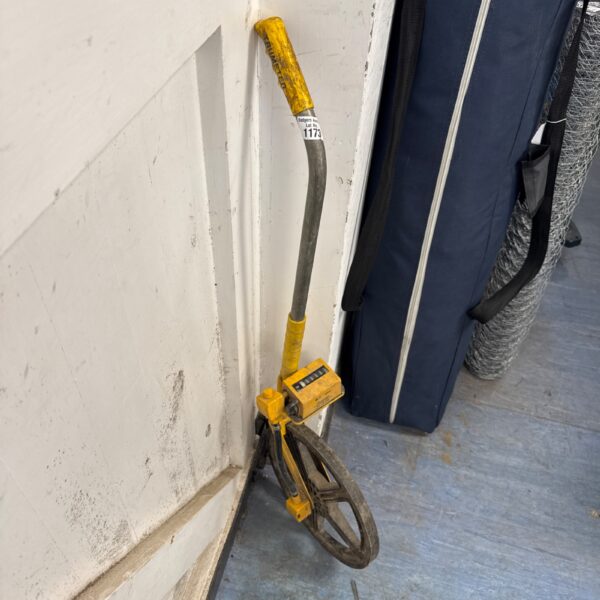 Yellow Trumeter surveyors wheel for distance measurement.