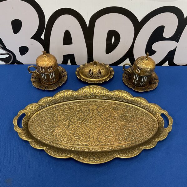 Vintage Turkish brass coffee set with ornate serving tray and cups.