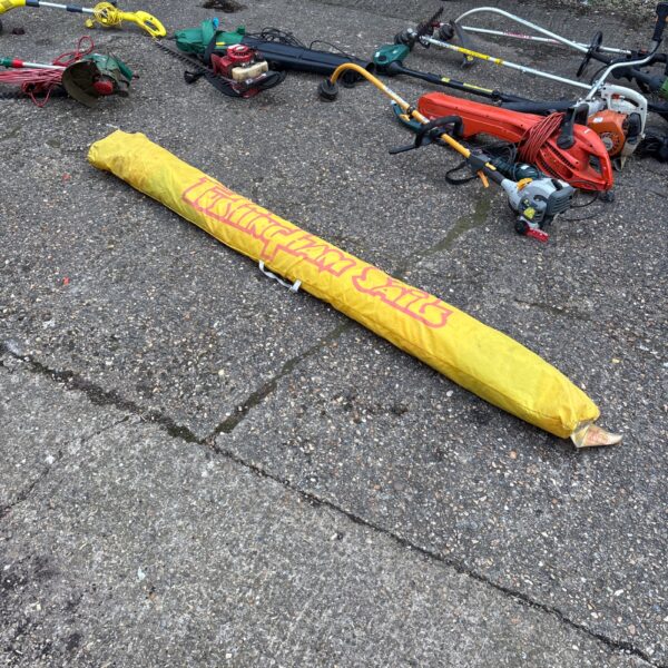 Vintage Tushingham Sails windsurf sail rolled up.