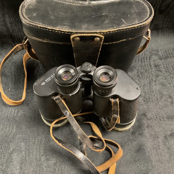 Vintage Soviet binoculars with case, showing wear and age.