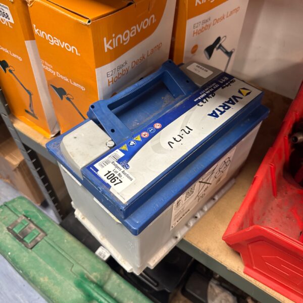 Side view of a used Varta E11 car battery.