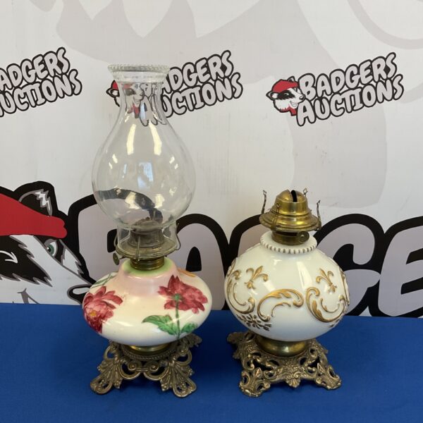 Antique Victorian milk glass oil lamps with floral details.