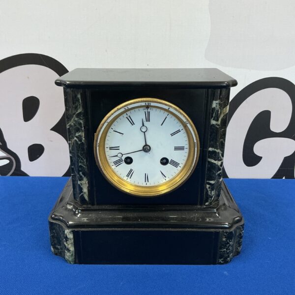 Antique Victorian slate mantle clock with marble accents.