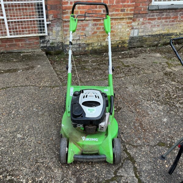 Front view of a used Viking petrol lawnmower in a garden setting.