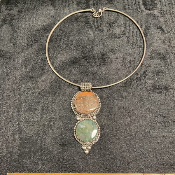 Close-up of vintage agate choker necklace with orange and green stones.