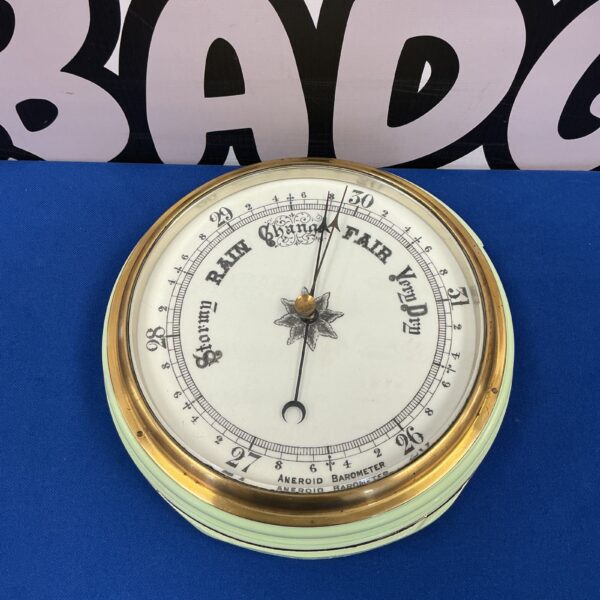 Vintage android barometer with enamel dial for weather forecasting.