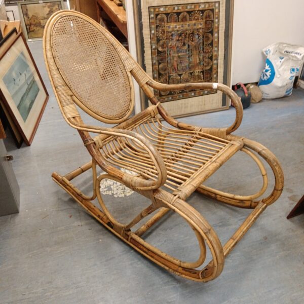 Vintage bamboo rocking chair with woven rattan back and seat.