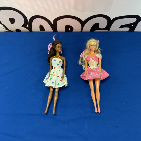 Vintage Barbie dolls in polka dot and striped outfits, collectible toys.