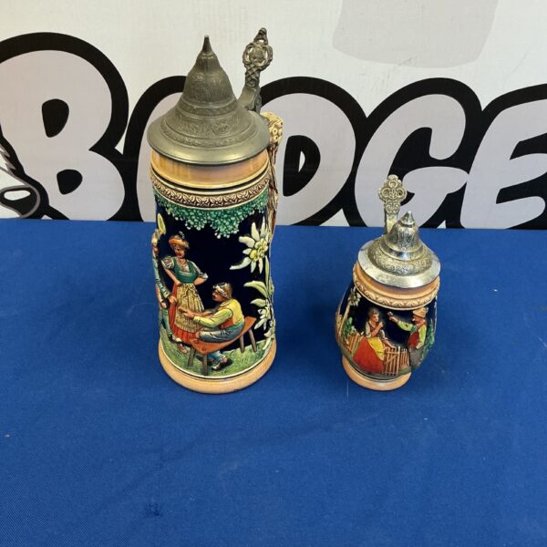 Detailed vintage beer stein with hand-painted scenes.