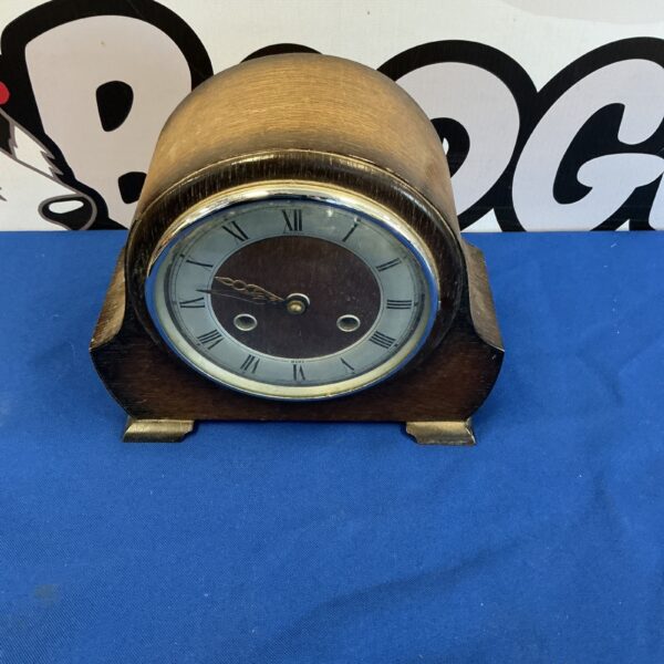 Vintage Benton clock with wooden case and Roman numeral dial.