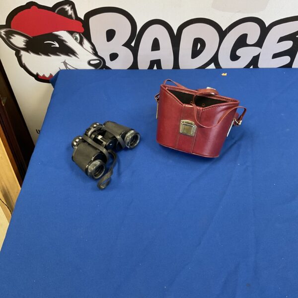 Vintage binoculars with a protective case, ideal for collectors.