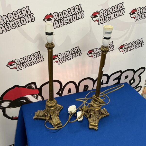 Vintage brass column lamps with cream shades, elegant lighting.
