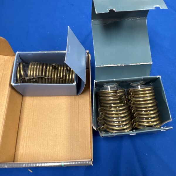 Vintage brass curtain rings in original packaging.