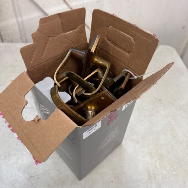 Vintage brass door handles in a box, antique hardware.