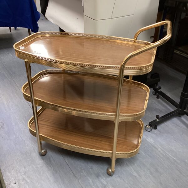 Vintage brass hostess trolley with three tiers for serving.
